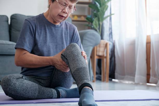 istock Mature female athlete with joint or muscle soreness and problem 1498309974