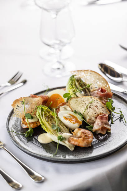 istock Modern version of a ceasar salad with shrimps served in a posh restaurant. 1498313103