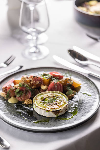 Goat cheese with baked beetroot salad styled on a plate in a restaurant.