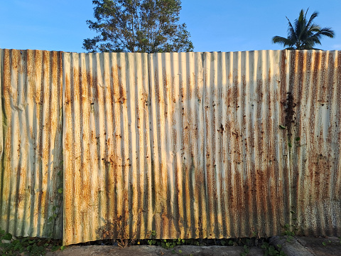 Old zinc vintage fence wall texture for background, pattern of rusty on metal panel.  Tin Roof wall countryside