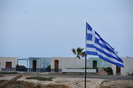 The Greek flag flies over a house in Crete, Greece