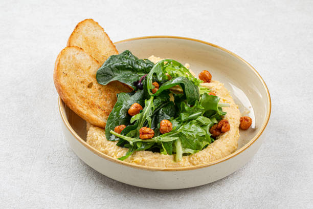 istock Portion of hummus with greens and toasts 1498322869