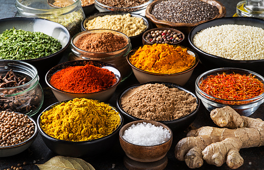 Colorful herbs and spices for cooking meal. Indian and Asian spices background closeup