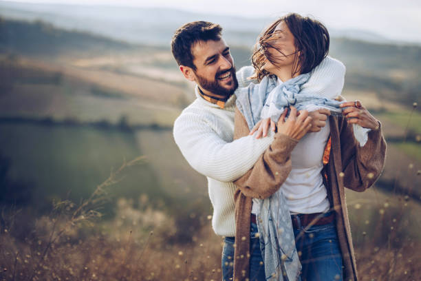 istock Young happy couple embracing with great affection during autumn day on a hill. 1498325035