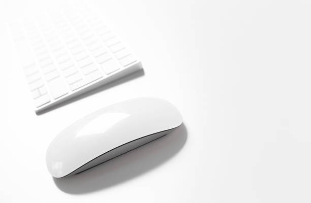 istock Computer keyboard and mouse on top of white desktop 1498325469