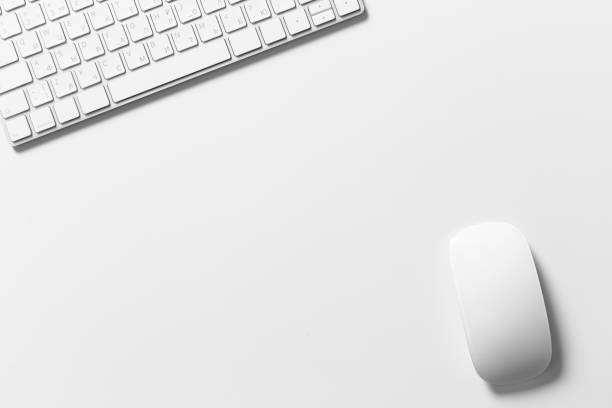 istock Computer keyboard and mouse on top of white desktop 1498328133