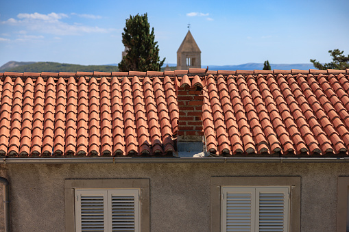 Orange colored tiles covering house roof in a town on the island of Rab in Croatia