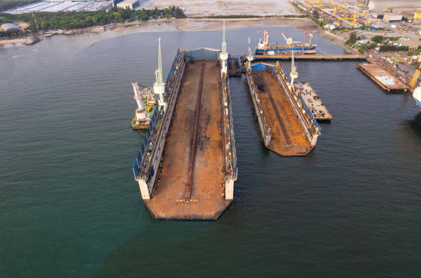 istock Dry dock with Cargo Ship maintenance or repair at floating dock in shipyard both deck crane loading during bring ship in to the dry dock. 1498328644