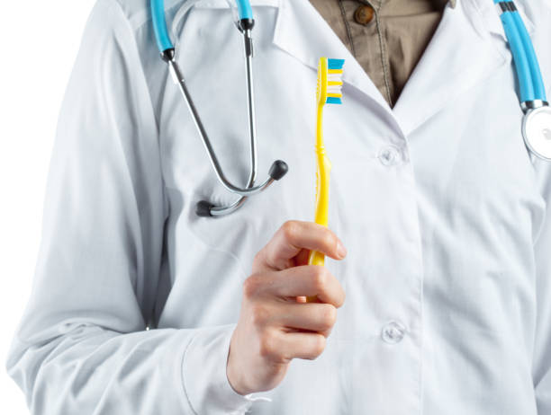 istock dentist showing toothbrush 1498328725