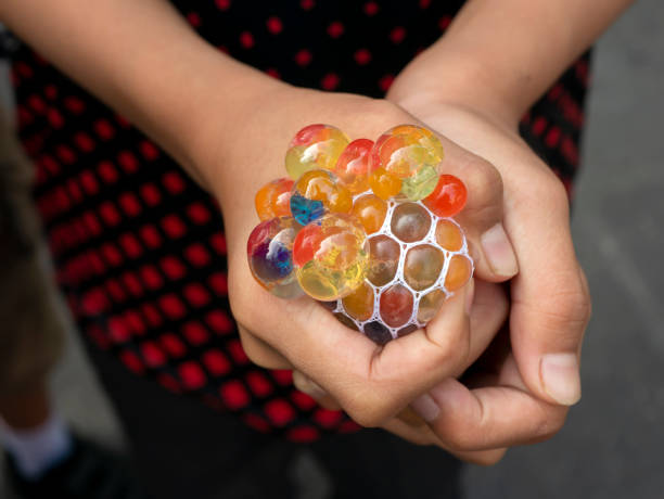 istock A kid holding and squeezing  a colorful stress relief grape balls 1498330404