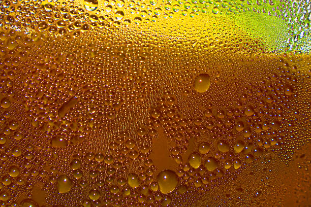 istock Drops of water on glass surface orange background, surface for creativity. 1498334807