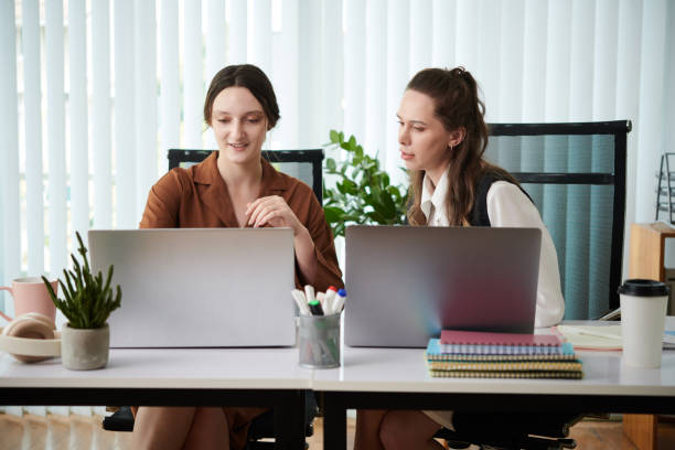 istock Colleagues working on laptop in office 1498335504