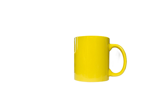 Yellow tea cup isolated on white background