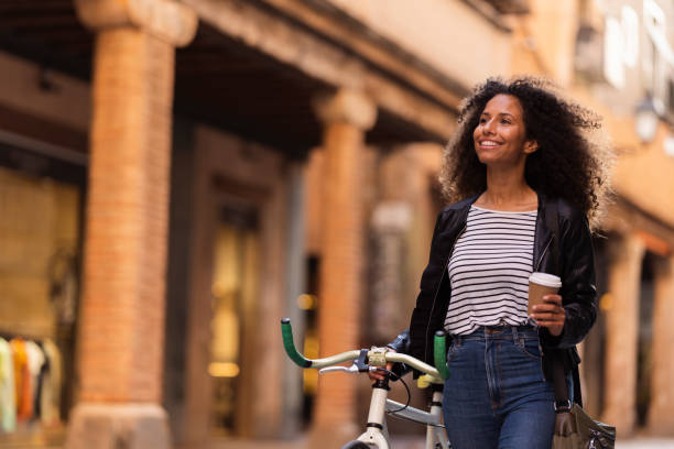 istock Female young hipster walking alongside bicycle outdoors in Barcelona 1498336840