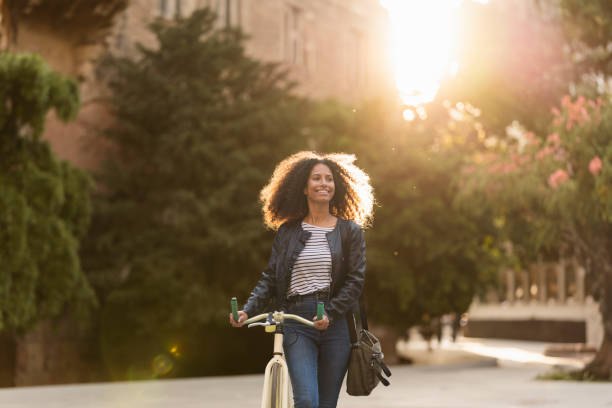 istock Afro-Style Grace: A Trendy Commuter in the City Park 1498337826