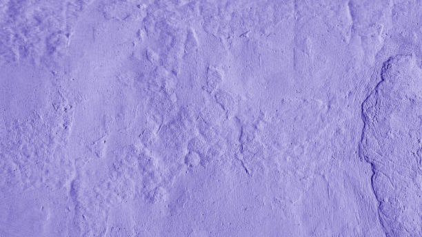 istock Stucco plaster wall background texture of purple painted cement, concrete wall 1498341932