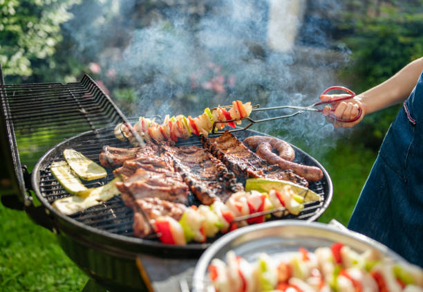 istock Woman barbecuing with open flame grill outdoor. 1498342451