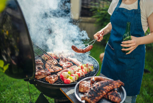 istock Woman barbecuing with open flame grill outdoor. 1498342493