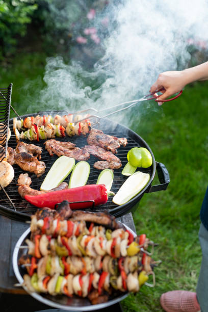 istock Woman making dinner on the grill barbeque. 1498342554