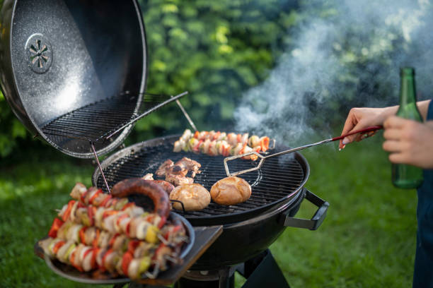 istock Woman making dinner on the grill barbeque. 1498342555