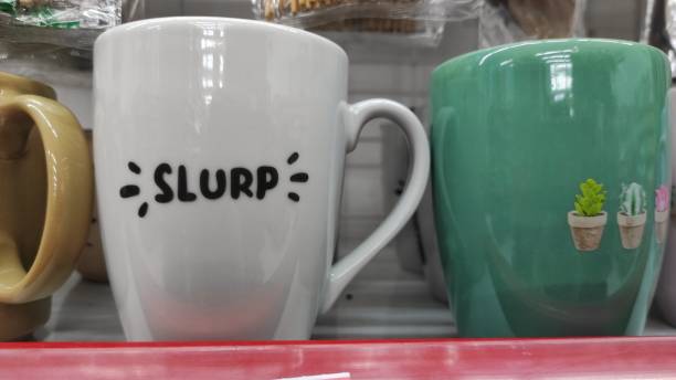 istock White ceramic mug with 'slurp' printing  on it 1498343810