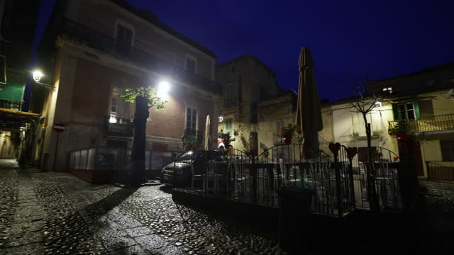 Charming piazza of an Italian town on a rainy night