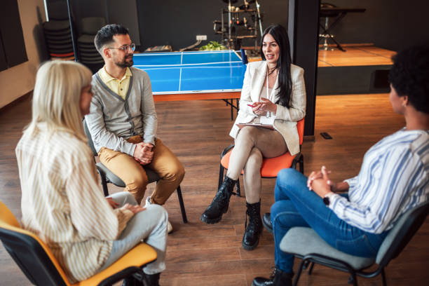 istock Support group patients on therapy session.Group therapy session, addiction treatment or team building. 1498352600