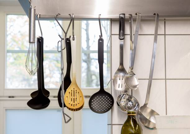 istock Row of decorative spats suspended from the ceiling in a kitchen setting. 1498353611