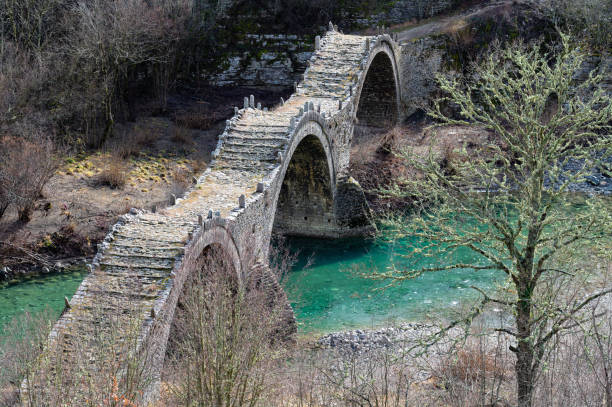Old bridge in Zagori, Greece View of the traditional stone Kalogeriko or Plakida Bridge in Zagori of Epirus, Greece in Autumn zagori stock pictures, royalty-free photos & images