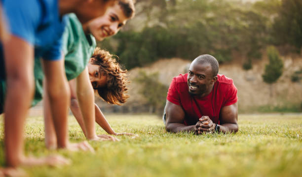 istock Rugby coach training a school team in a field 1498360830