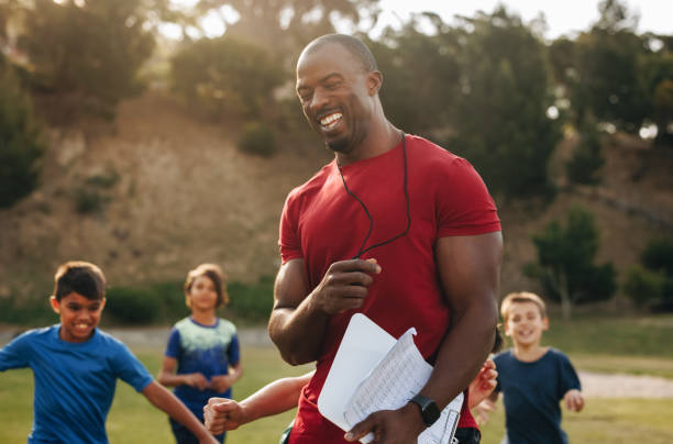 istock Coach having a fun training session with kids in a school 1498360907