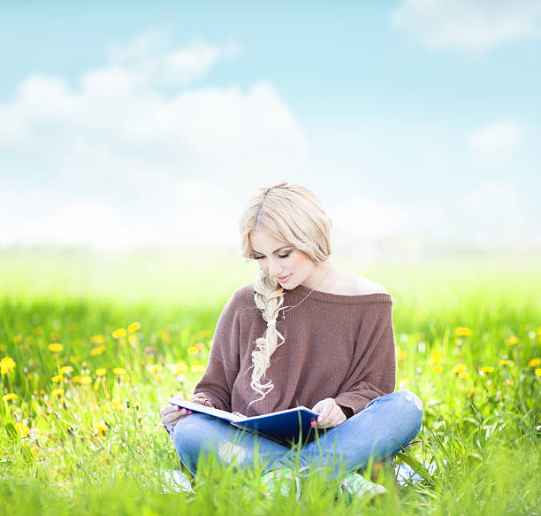 istock Young woman reading in the nature 149836097
