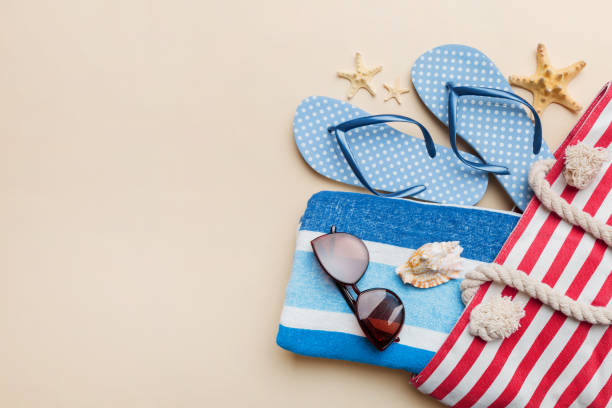 istock beach accessories flat lay top view on colored background Summer travel concept. Bag with starfish and sea shell. Top view 1498361094