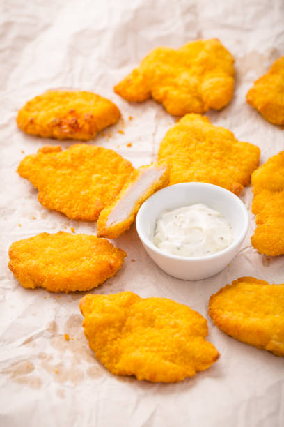 istock Small chicken schnitzel on baking sheet with herb mayonnaise 1498365319