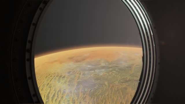 Through the porthole of the spacecraft, the surface of an unknown planet is visible