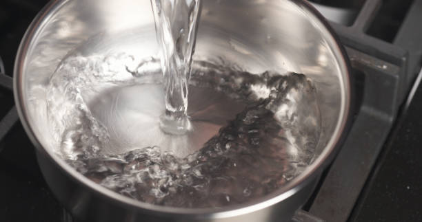 istock Handheld shot of pouring water into saucepan 1498371144