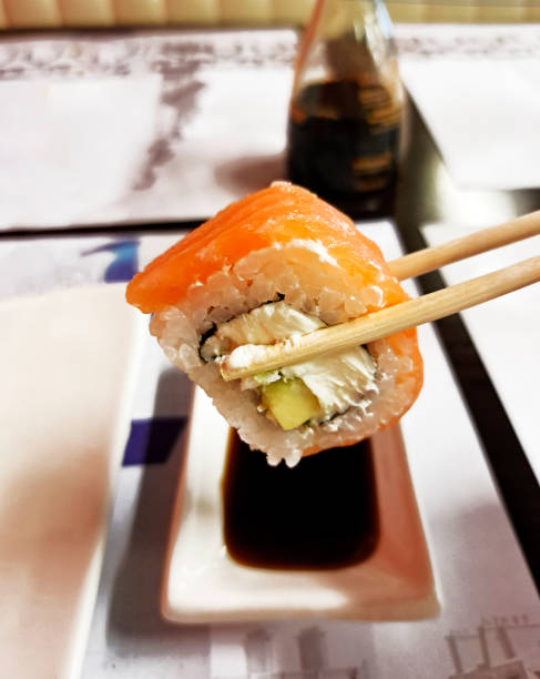 Sushi with salmon and wasabi on a white plate. Japanese and Chinese food