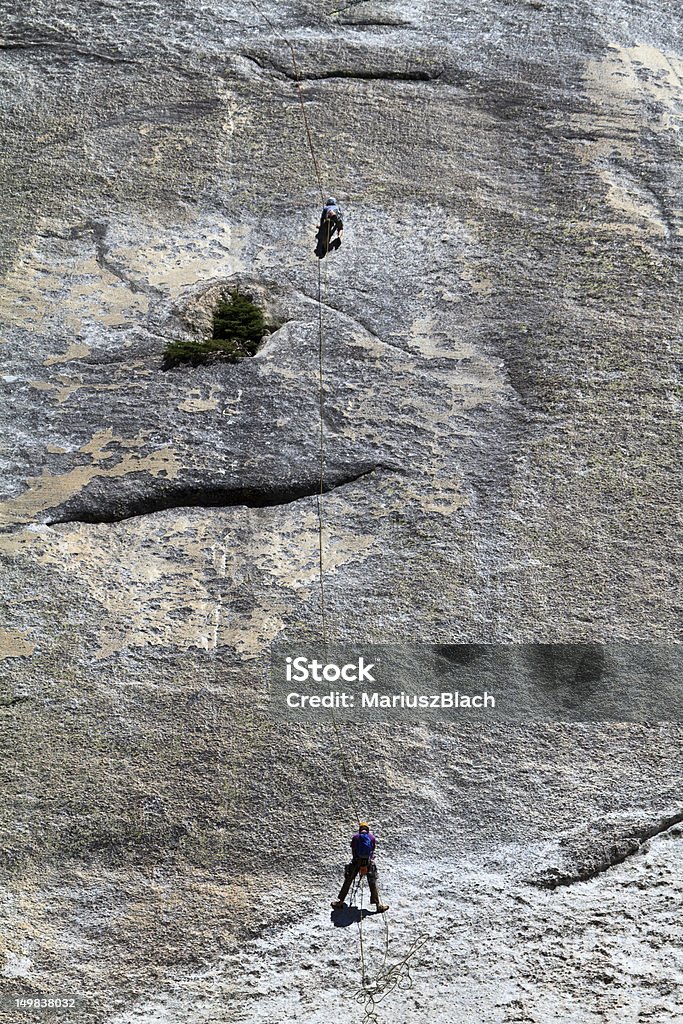 rock climbing two climbers on a cliff Adventure Stock Photo