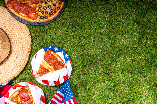 july 4th holiday party pizza, Fourth of July, Patriotic Independence day festive and picnic food. Pepperoni, tomato and black olive pizza with lot of mozzarella, in form of American flag