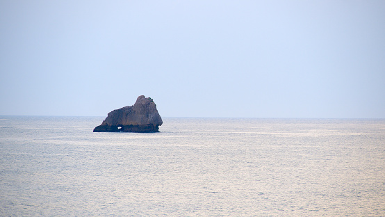 rock in the middle of the sea