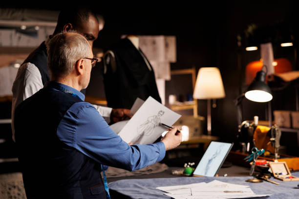 istock Tailors checking fashion sketches 1498385803