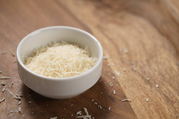 istock grated aged italian parmesan cheese in white bowl on table 1498386706