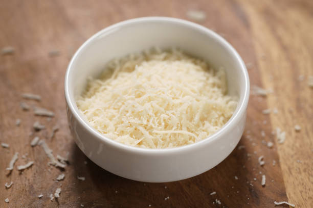 istock grated aged italian parmesan cheese in white bowl on table 1498387968