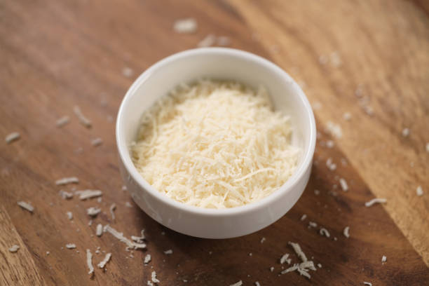 istock grated aged italian parmesan cheese in white bowl on table 1498388021