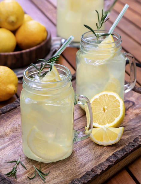 istock Lemonade with sliced lemons, ice and rosemary 1498388571