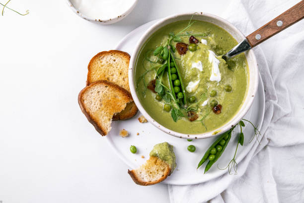 istock Fresh green peas cream soup with toasts. 1498390416