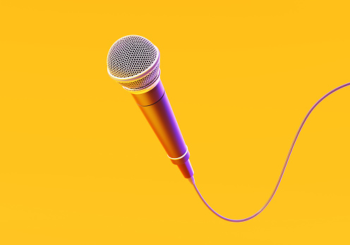 Microphone on yellow background. Horizontal composition with copy space.