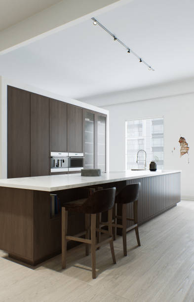 istock Kitchen minimalism. Wooden kitchen with large long island and bar stools. Kitchen with marble top and wooden bottom. 3d render 1498399294