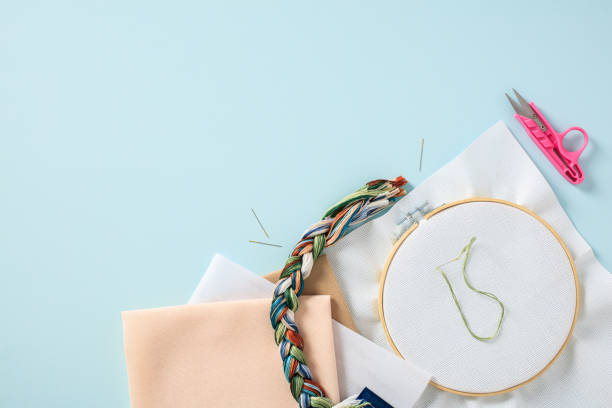 istock Flat lay handicraft embroidery materials and accessories on blue background. 1498400018