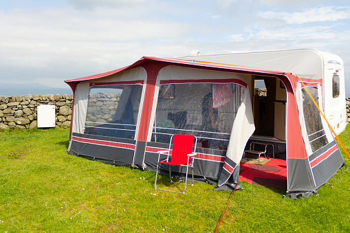 Caravan and awning set up for vacation in Welsh countryside, home from home for family enjoying the outdoor life for a while .